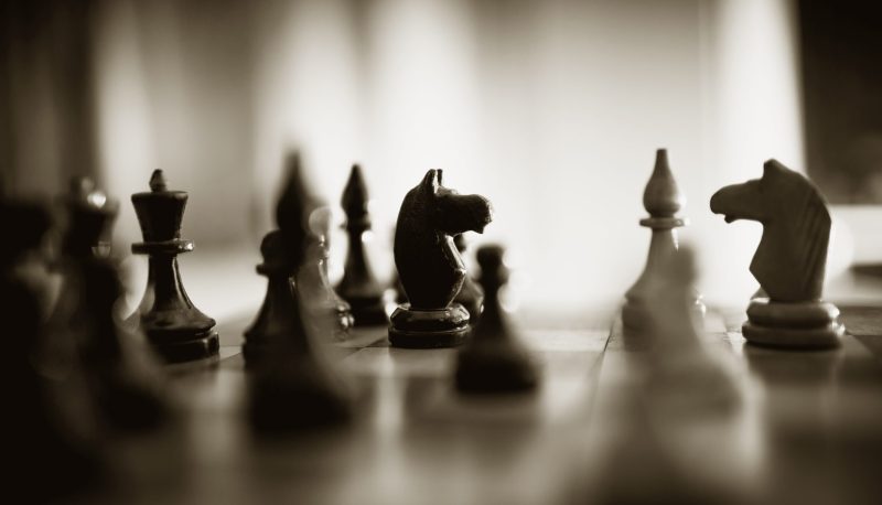 A photograph of chess pieces on a chess board.
